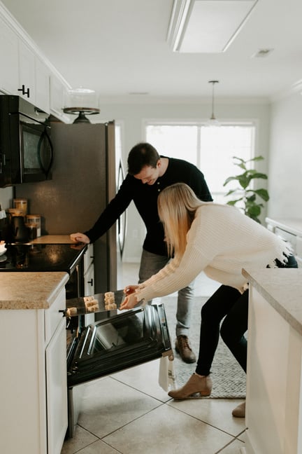 couple-baking-in-their-new-home-down-payment-assistance-Reazo-real-estate