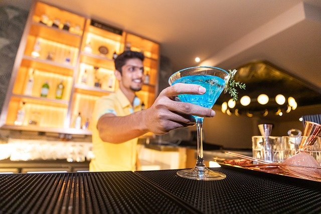 vegas-bartender-serving-blue-drink-Reazo-real-estate